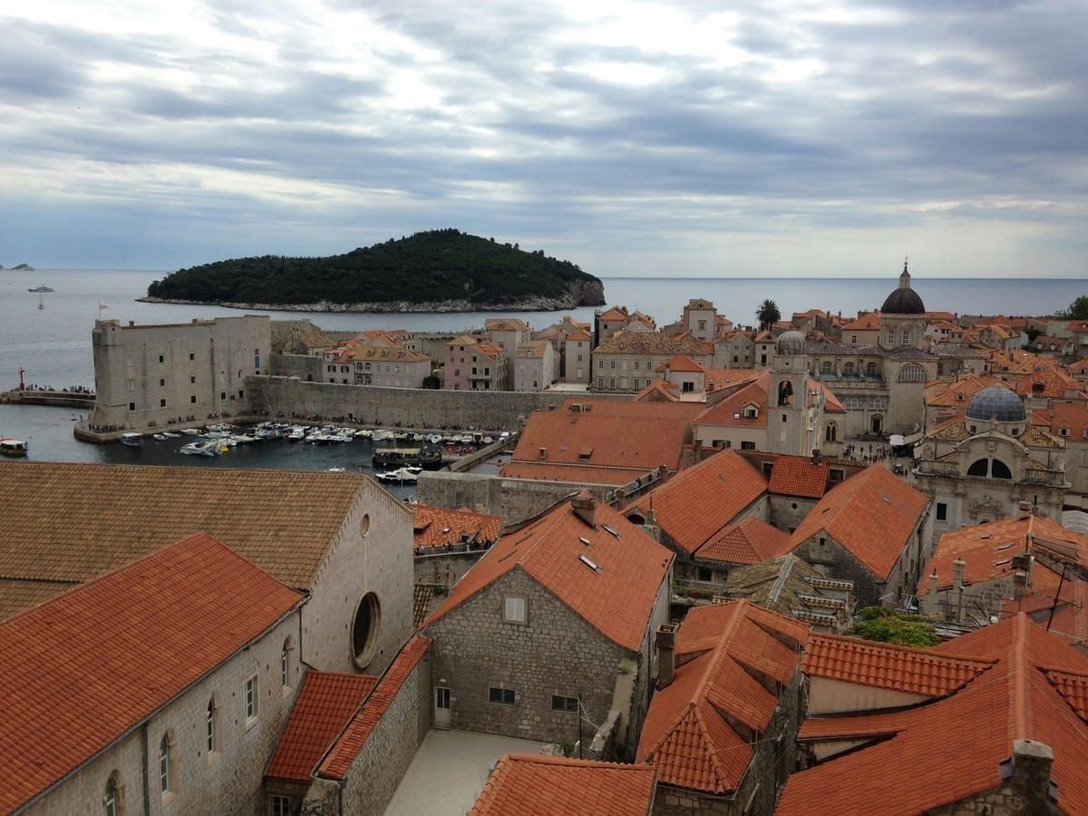 Blick über die roten Dächer und Stadtmauern der Altstadt von Dubrovnik aufs Meer