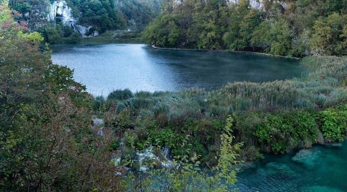 Hölzerne Stege und türkisgrüne Wasserfälle im Nationalpark Plitvicer Seen